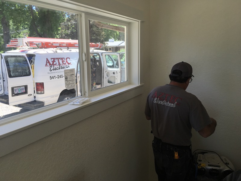 Electrician working on rewiring a home.